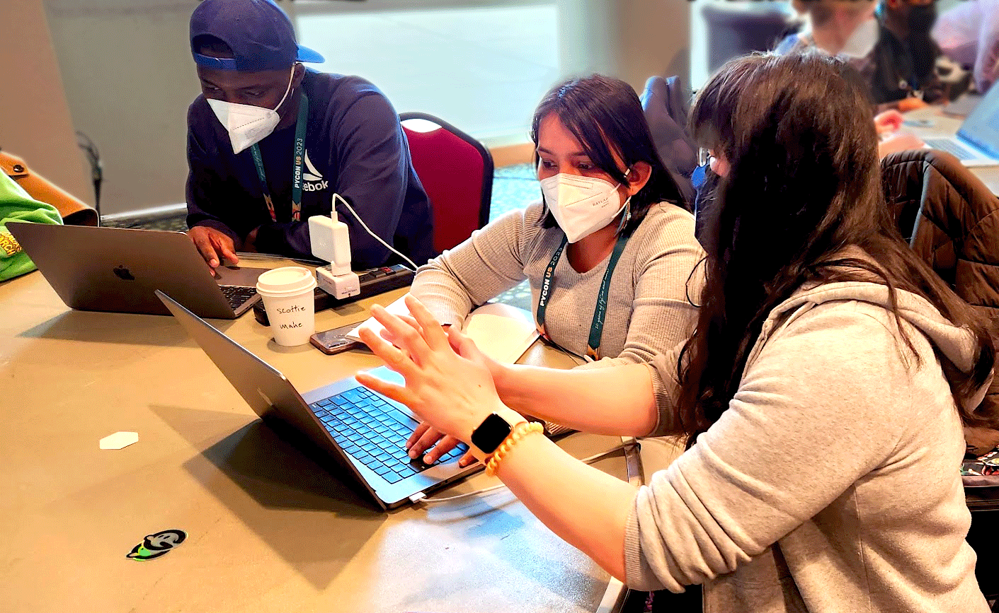People working at computers during a pyCon USA sprint.